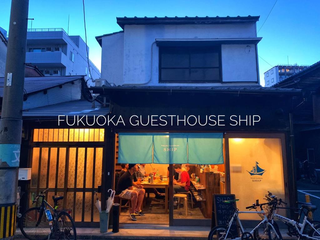 a restaurant with people sitting at a table in the window at Fukuoka Guesthouse SHIP in Fukuoka