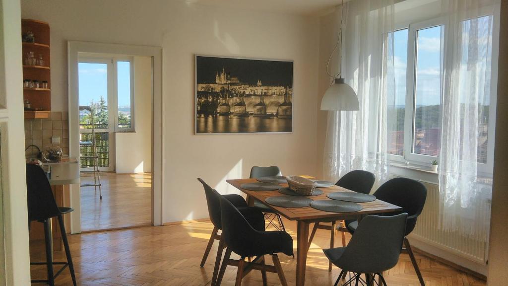 a dining room with a table and chairs at Apartmán Malvazinky in Prague