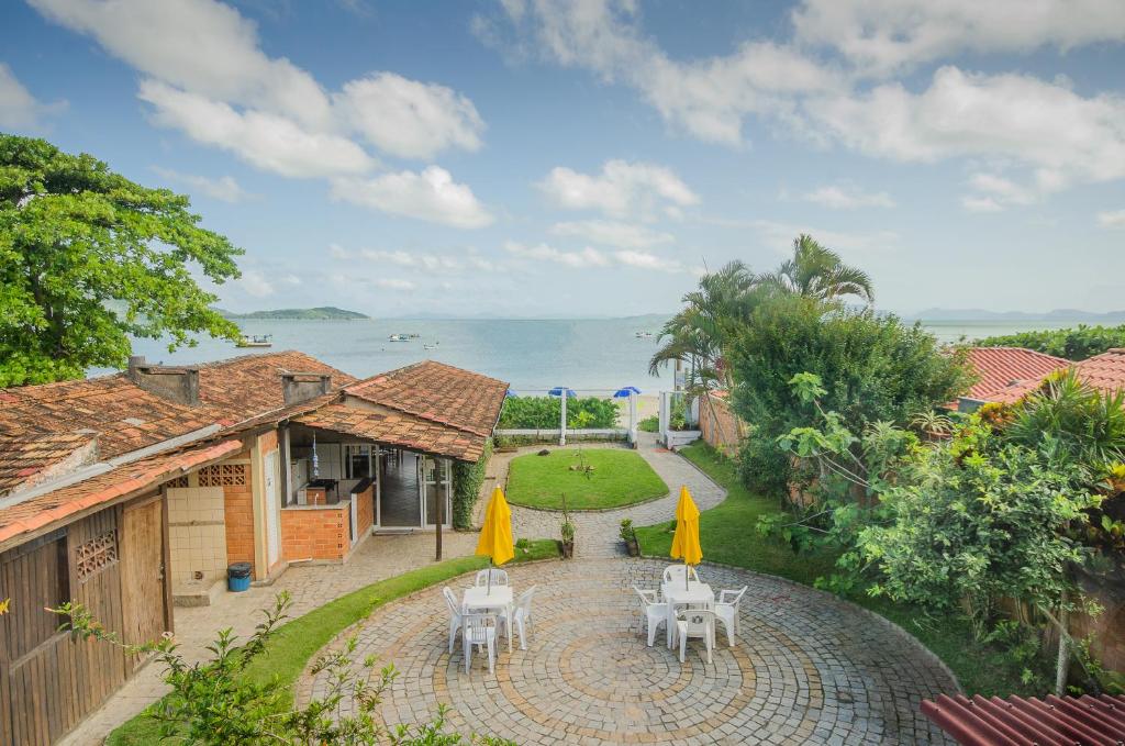 an aerial view of a house with tables and chairs at Pousada Oceânica in Bombinhas