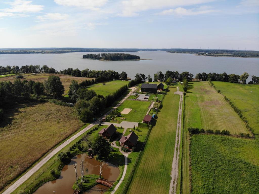 an aerial view of a farm near a body of water at Punkt Mazury in Sędki