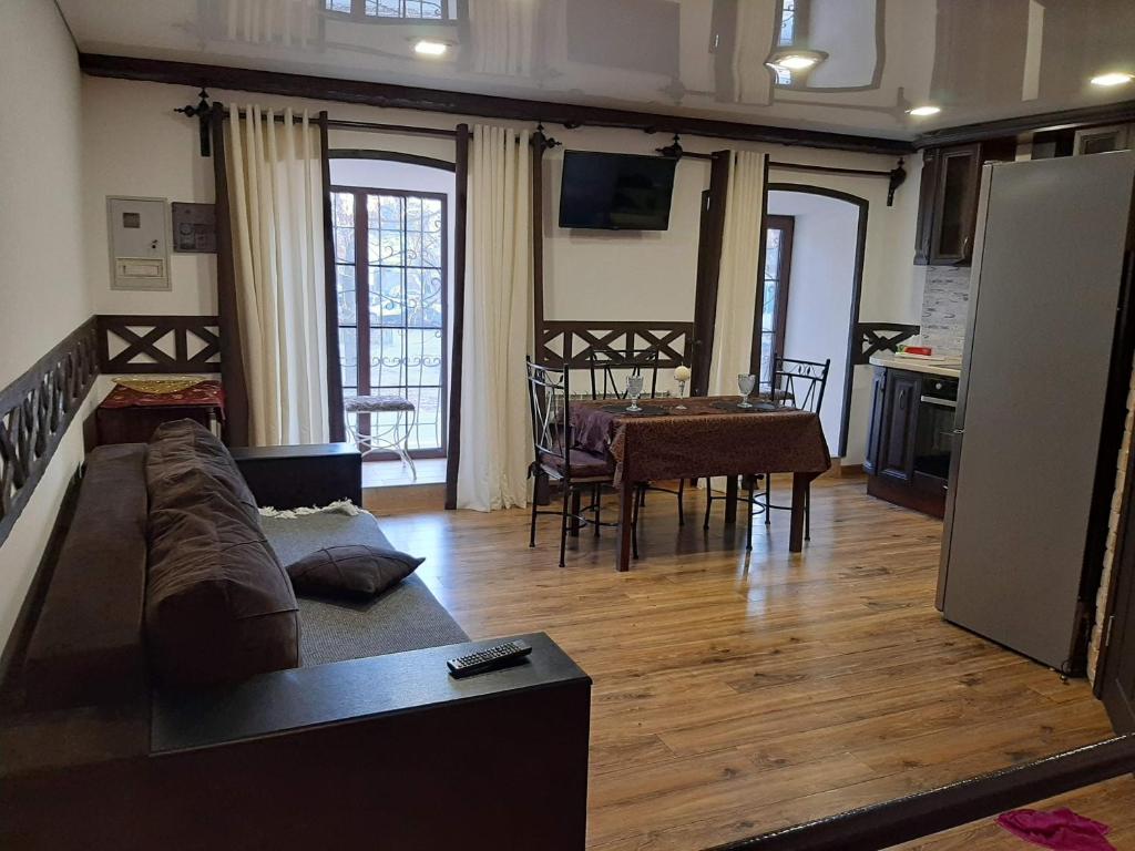 a living room with a couch and a dining room at Charlotte -двухуровневая Студия в Центре in Kremenchuk