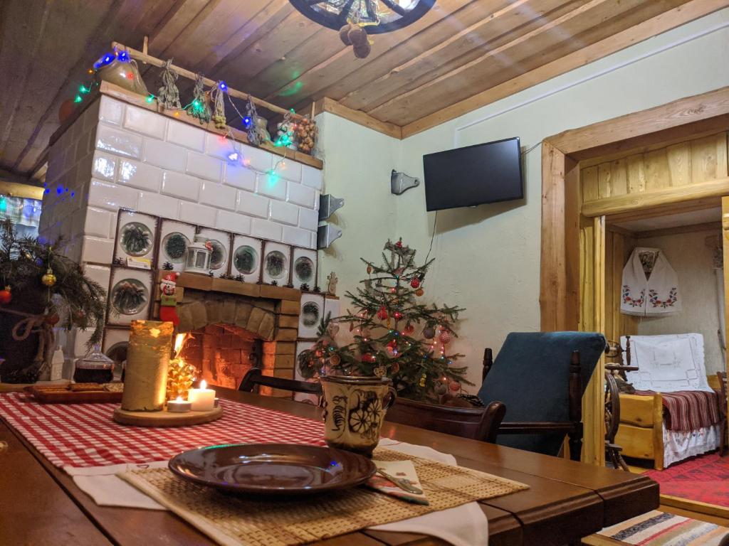 a living room with a christmas tree and a table at Agrousadba UTSISHY - U hutarskoj tsishy, Volkovysk in Vawkavysk