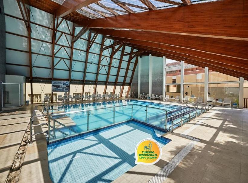 a large swimming pool in a building at Dall’Onder Grande Hotel Bento Gonçalves in Bento Gonçalves