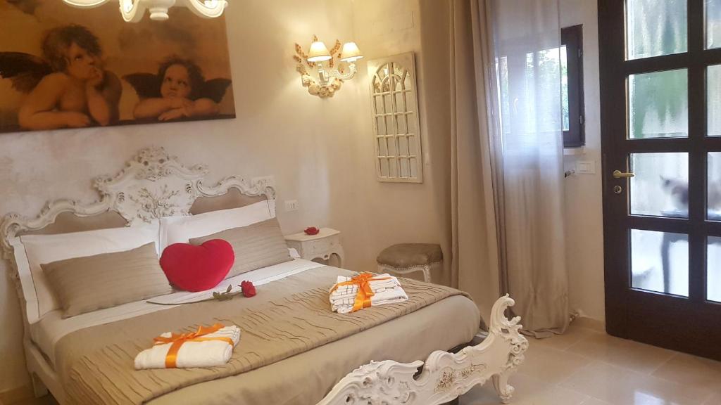 a bedroom with a white bed with a heart on it at Stella del Mar in Bologna