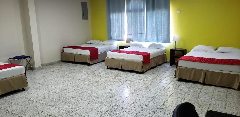 Postel nebo postele na pokoji v ubytování Hotel El Dorado