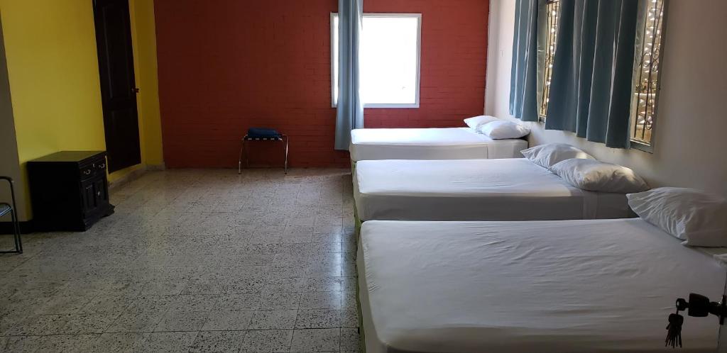 Postel nebo postele na pokoji v ubytování Hotel El Dorado