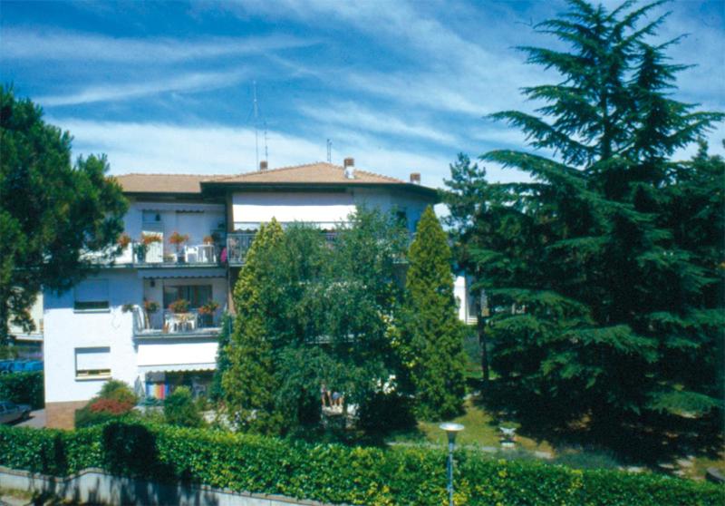 a building with a balcony with people on it at Villa Adria in Lignano Sabbiadoro