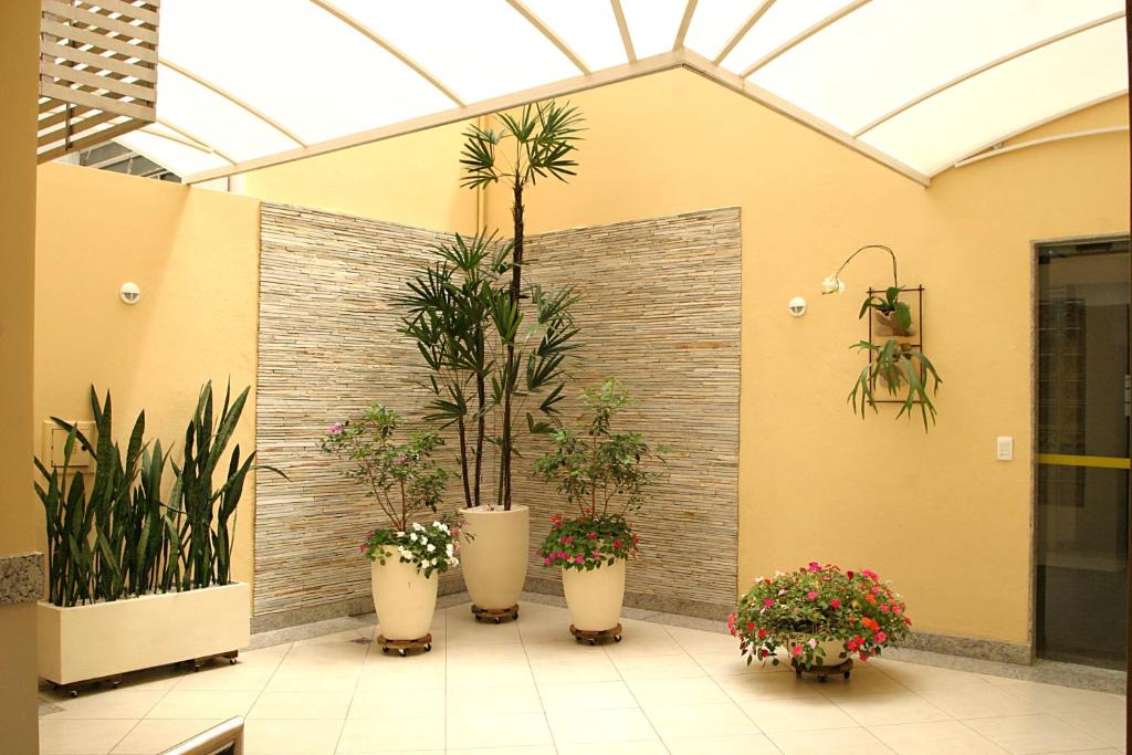 a group of potted plants in a building at Hotel São Bento in Belo Horizonte