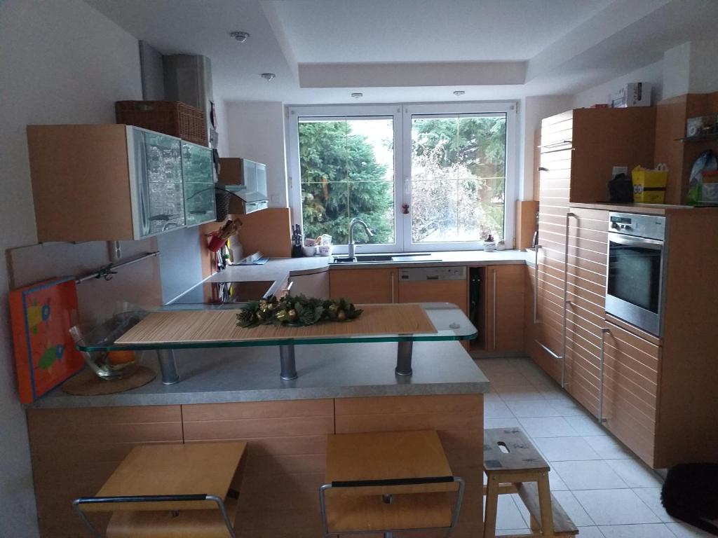a kitchen with a table in the middle of it at Villa Kysucka in Senec