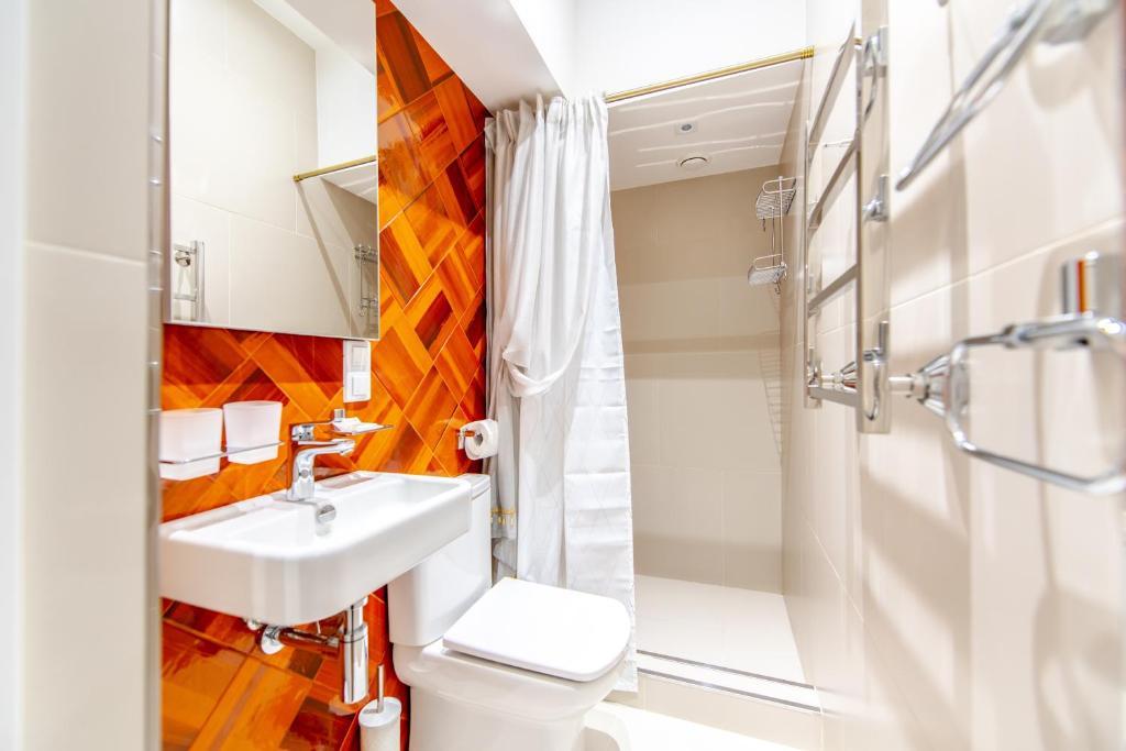 a bathroom with a sink and a toilet and a shower at Namaste Aparthotel in Krasnaya Polyana