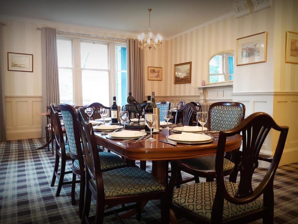 uma sala de jantar com uma mesa de madeira e cadeiras em The Speyside Hotel and Restaurant em Grantown-on-Spey