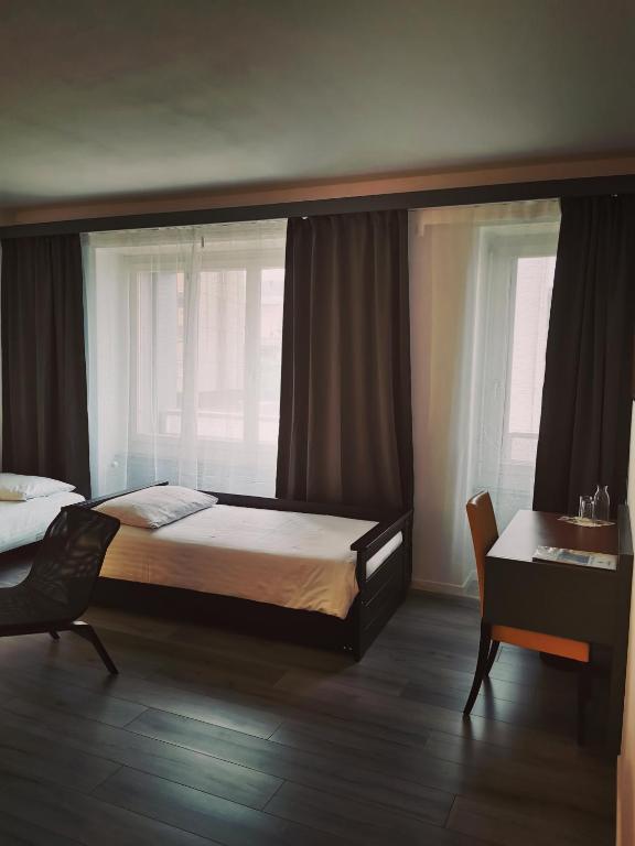 Postel nebo postele na pokoji v ubytování Hotel Fleur-de-Lys