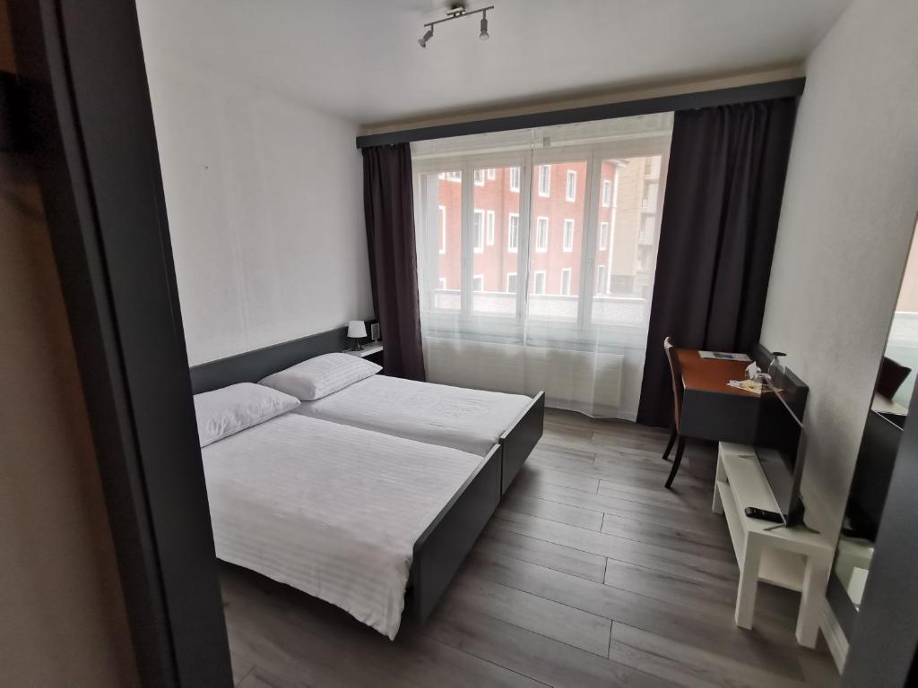 Postel nebo postele na pokoji v ubytování Hotel Fleur-de-Lys