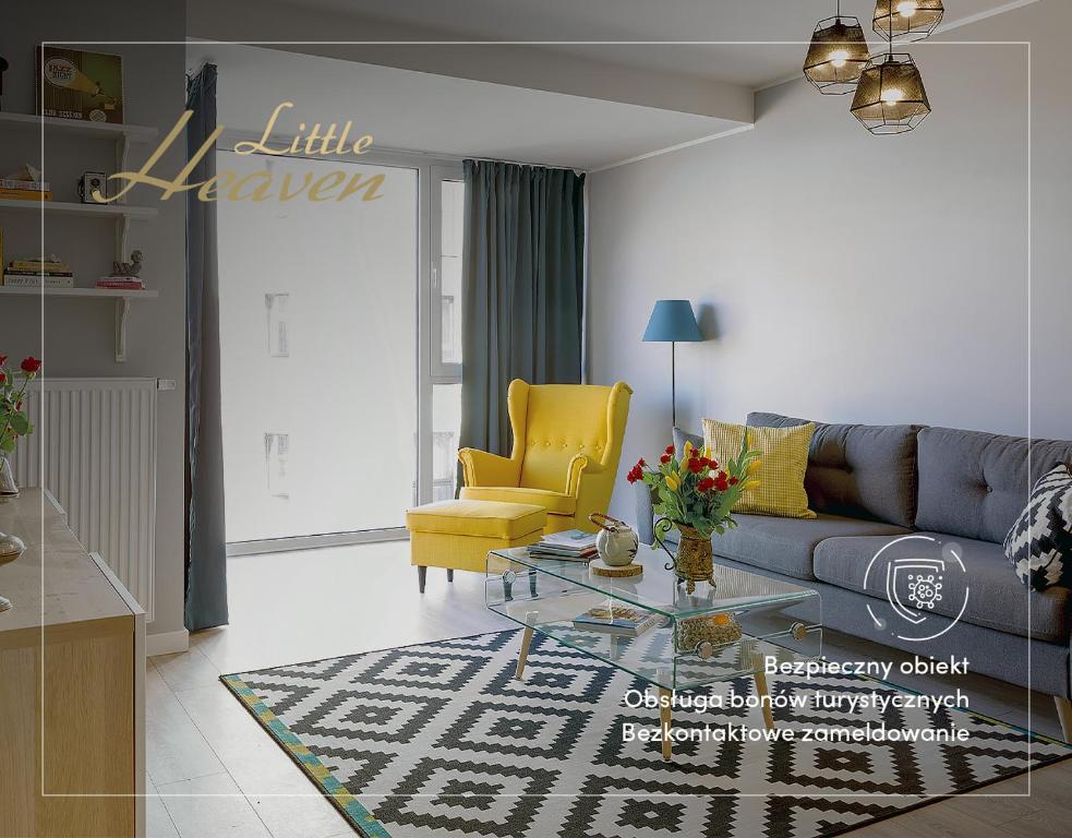 グダニスクにあるLittleheaven Studia & Apartmentyのリビングルーム(ソファ、黄色の椅子付)