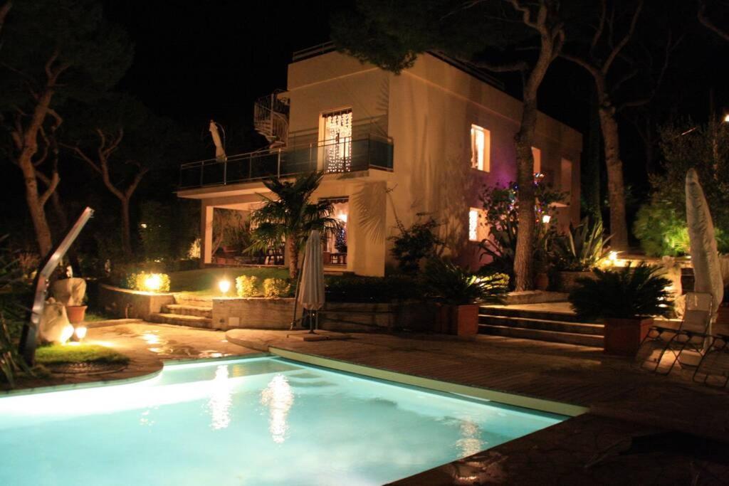 a swimming pool in front of a house at night at Villa Floriane in Cassis