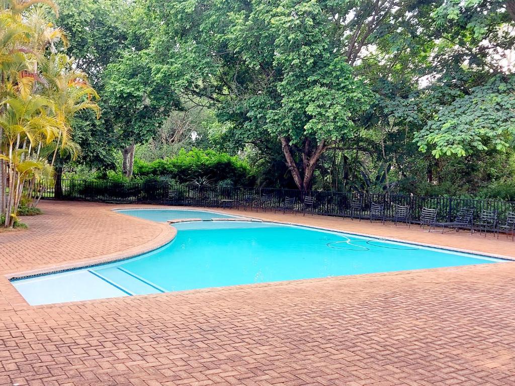 a small blue swimming pool on a brick road at Beautiful Family Breakaway in Secure Resort in White River