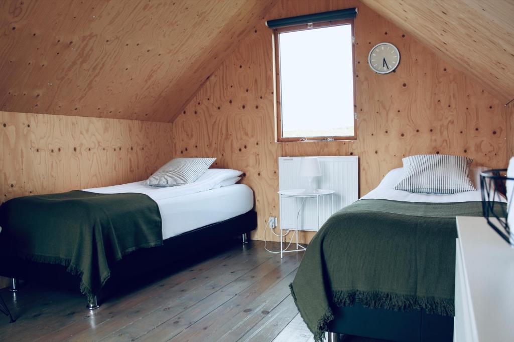 a bedroom with a bed and a window at iStay Cottages in Sandgerði
