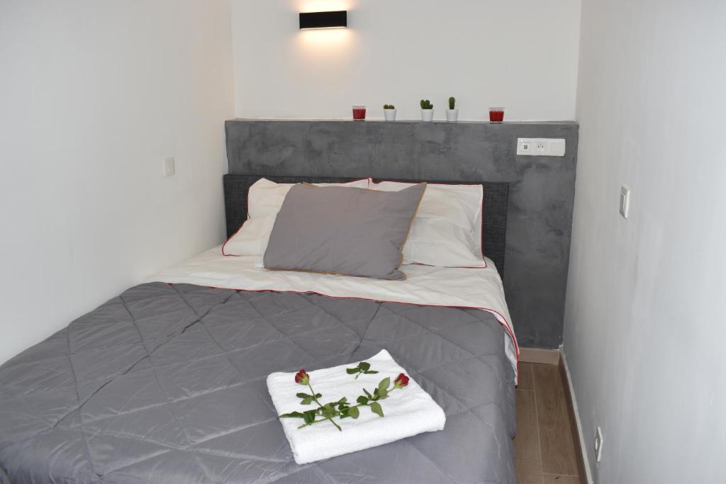a bedroom with a bed with two towels on it at Exotika - appartement de charme, Rouen in Rouen