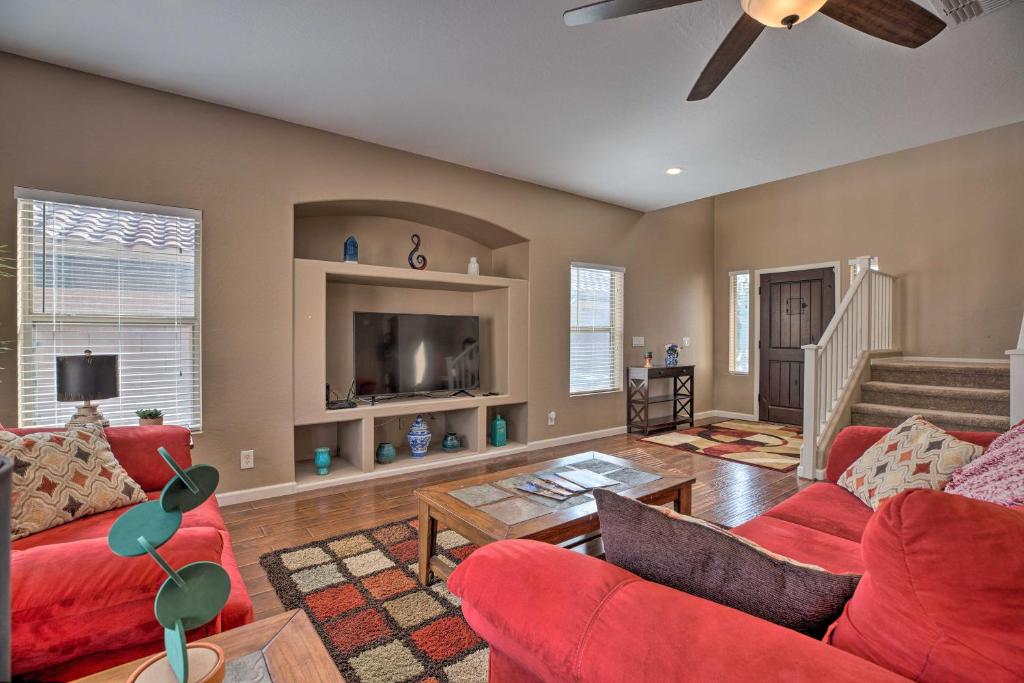 a living room with red furniture and a tv at Maricopa Home with Outdoor Seating, 2 Mi to Golf! in Maricopa