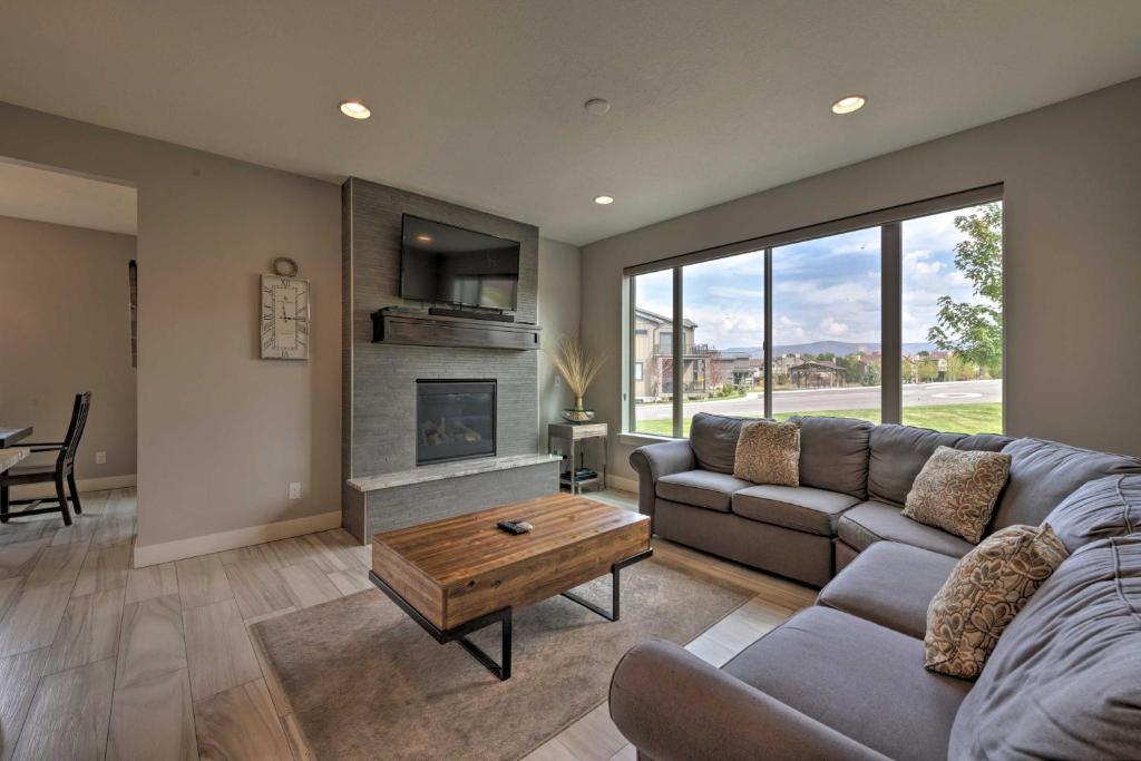 a living room with a couch and a fireplace at Modern Huntsville Resort Retreat with Deck and Hot Tub in Huntsville