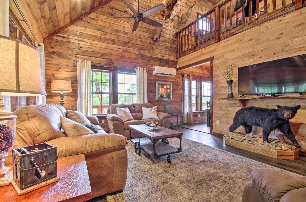 - un salon avec une statue d'ours dans une cabine dans l'établissement Secluded Log Cabin with Decks, Views and Lake Access, à Elizabeth
