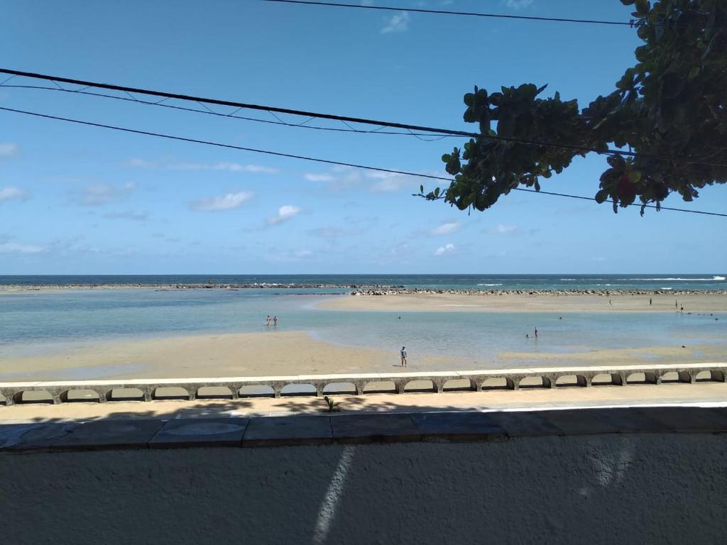 - une vue sur la plage avec des gens dans l'eau dans l'établissement Flat beira mar, Olinda 4 Rodas 309, à Olinda