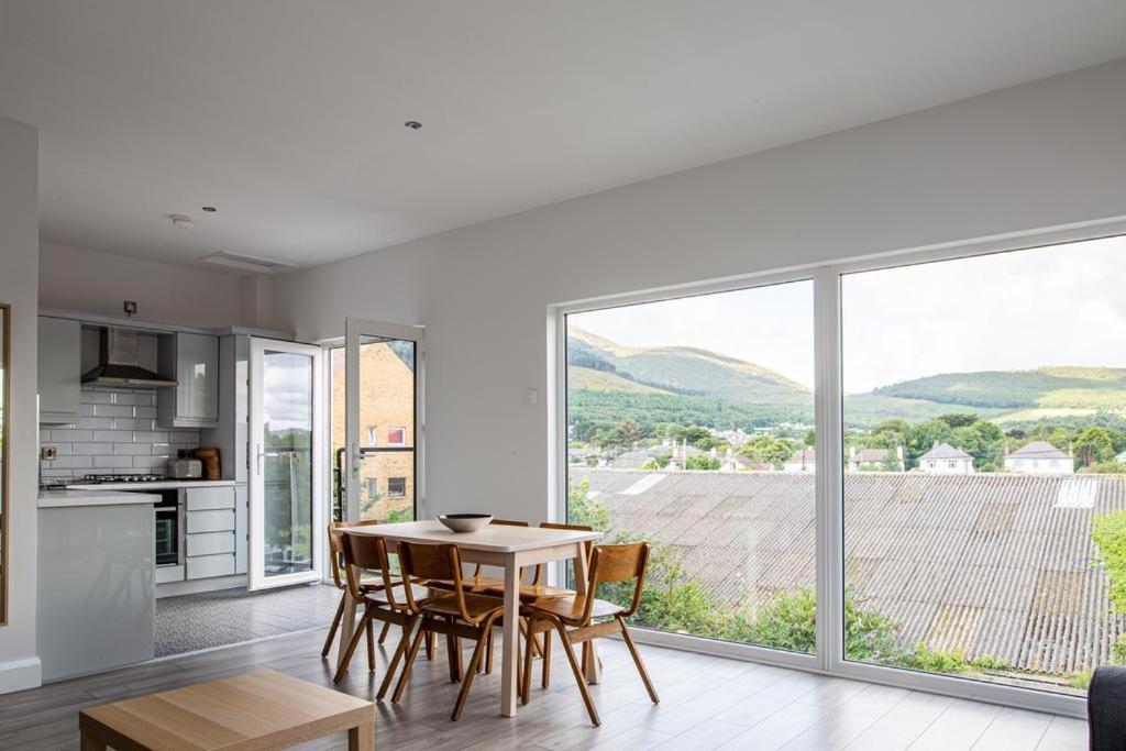 a kitchen and dining room with a table and a large window at The Views in Newcastle