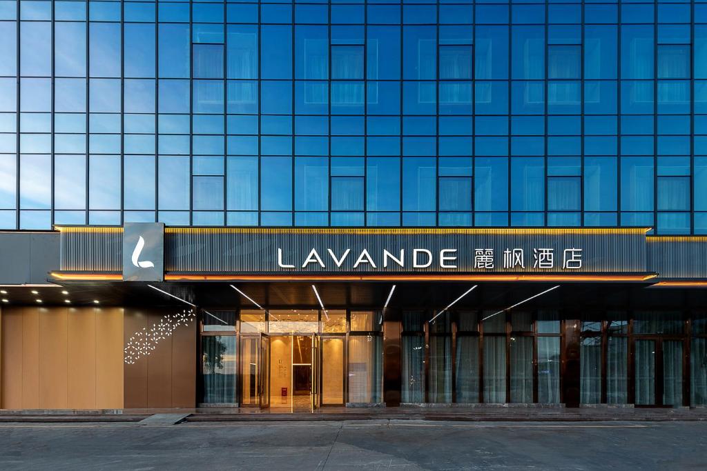 a large glass building with a sign that readslevantamine line at Lavande Hotel Shenzhen Baoan International Convention and Exhibition Center in Shenzhen