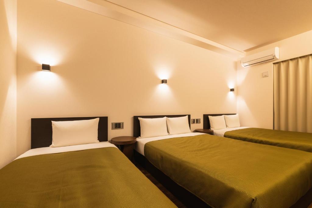 Postel nebo postele na pokoji v ubytování Hotel Iori