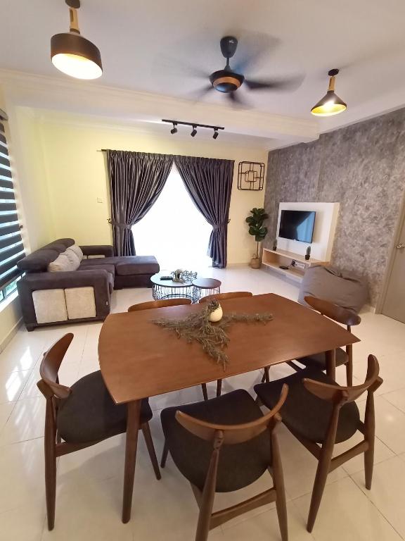 a living room with a table and chairs and a couch at Cameron Emerald Avenue @ Brinchang in Cameron Highlands
