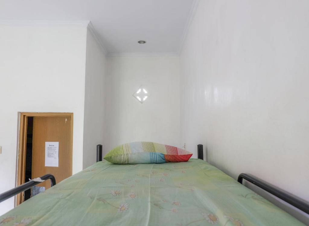 Postel nebo postele na pokoji v ubytování Umah Hijau Tabanan
