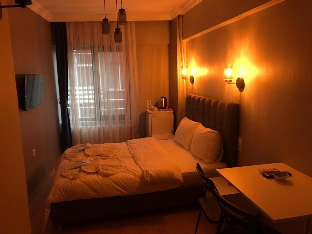 Ένα ή περισσότερα κρεβάτια σε δωμάτιο στο Zion Home Butik Otel