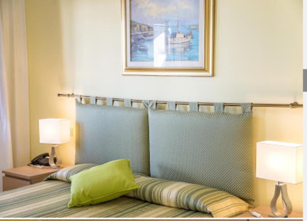 Postel nebo postele na pokoji v ubytování Hotel Calabattaglia