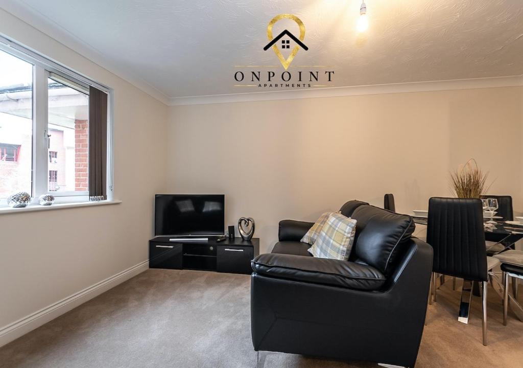 a living room with a couch and a tv at OnPoint - Spacious 2 Bed Apt - FREE Parking in Reading