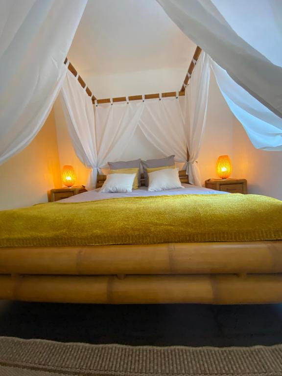 a bedroom with a bed in a tent at Kourline Villalunoterie Futuroscope Piscine spa in Oyré