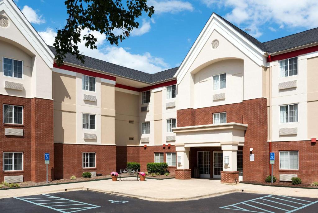 una imagen de un edificio de apartamentos con aparcamiento en MainStay Suites Raleigh - Cary, en Raleigh