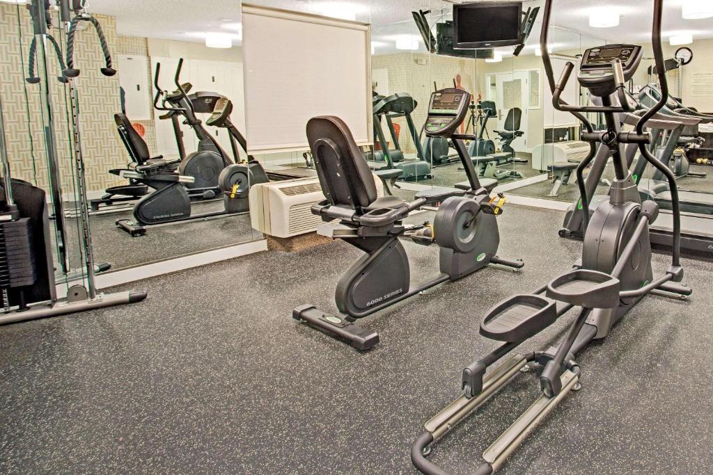 a gym with several treadmills and exercise bikes at MainStay Suites Omaha Old Mill in Omaha