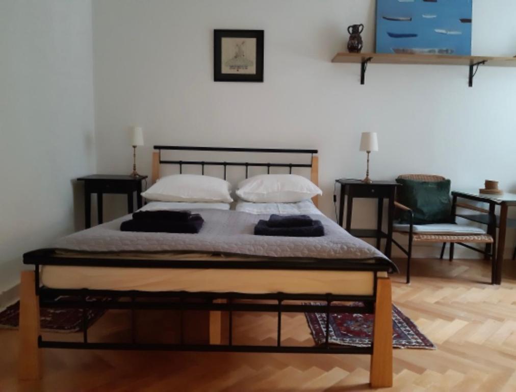 a bedroom with a bed, chair, and table at Dziesiątka in Olsztyn