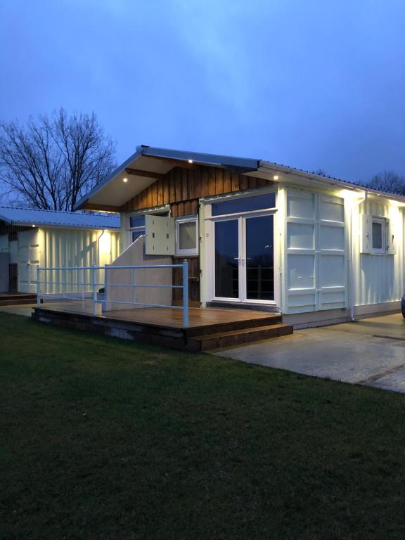 a large house with a porch and a deck at Lake View Lodge in Chichester