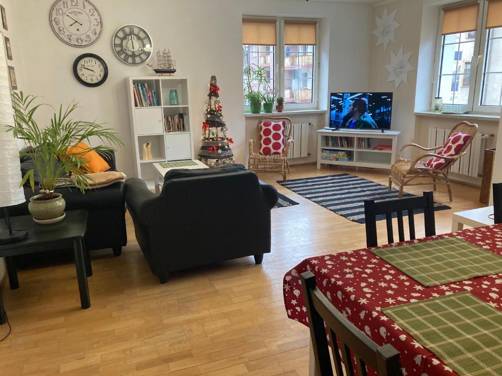 a living room filled with furniture and a christmas tree at Apartament Centrum in Kołobrzeg