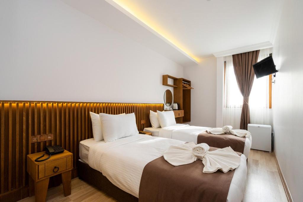 A bed or beds in a room at Castillo Rojo Hotel Istanbul