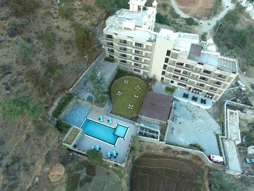 an aerial view of a building with a swimming pool at Bodhi A Boutique Hotel Kumbhalgarh in Kumbhalgarh