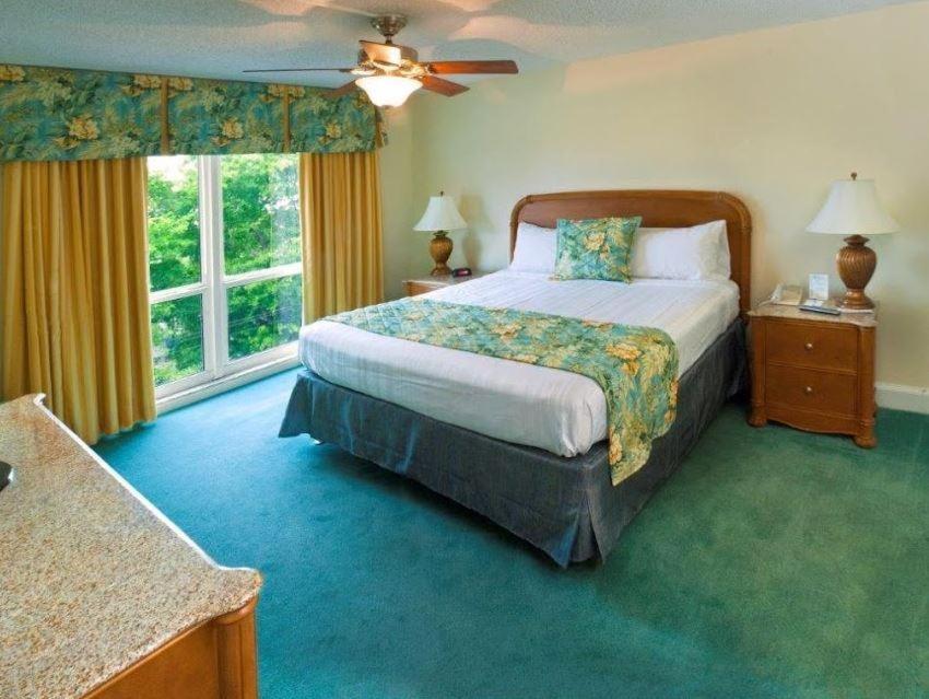 a bedroom with a bed and a large window at Ft Lauderdale Beach resort in Fort Lauderdale