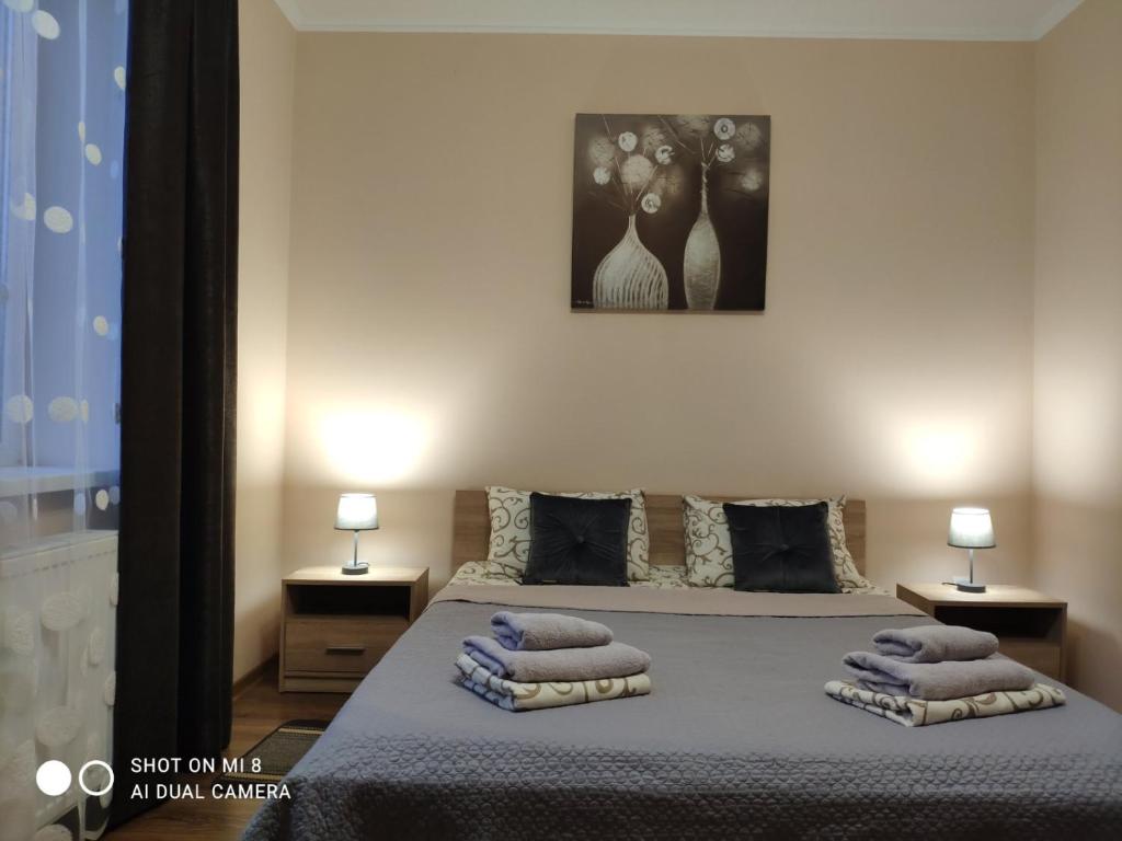 a bedroom with a bed with towels on it at Apartments Domovik Мостова 5 кв 44 in Mukacheve