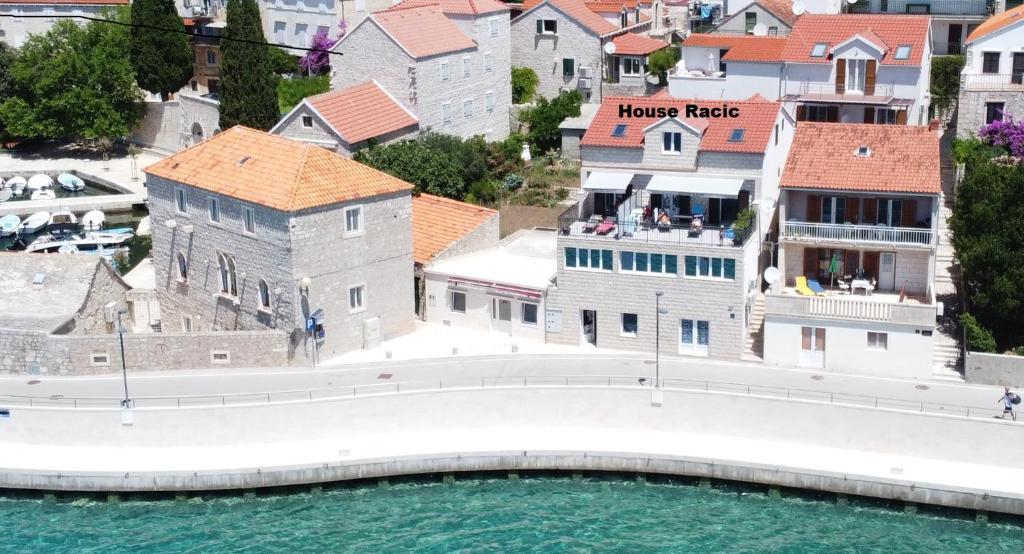 an aerial view of a house tactic building next to the water at House Racic in Bol