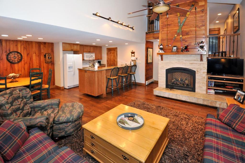 a living room with a couch and a fireplace at Courtside 23 - Spacious East Vail Townhome in Vail
