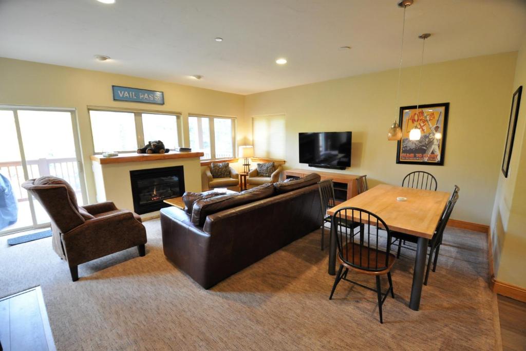 a living room with a couch and a table at Beautiful East Vail 3 Bedroom Condo w/Hot Tub On shuttle Route. in Vail