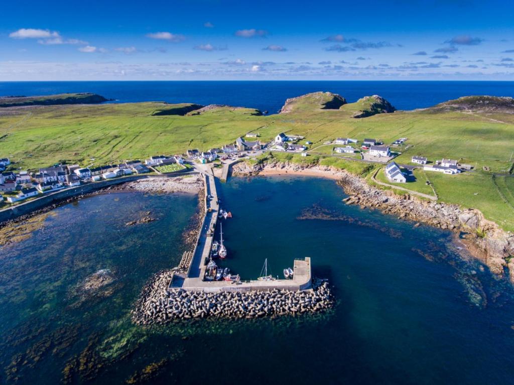an aerial view of a small island in the water at Ostán Oileán Thoraí Tory Island Hotel in Tory Island