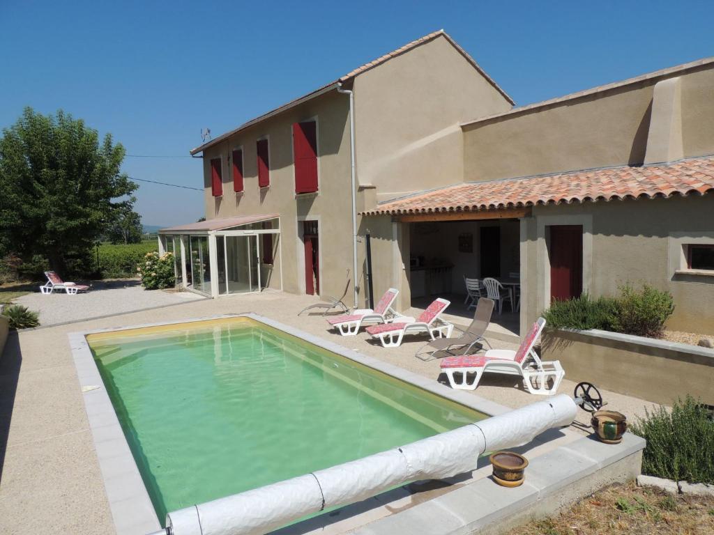 a swimming pool in front of a house at Cosy Holiday Home in Provence with Swimming Pool in Rasteau