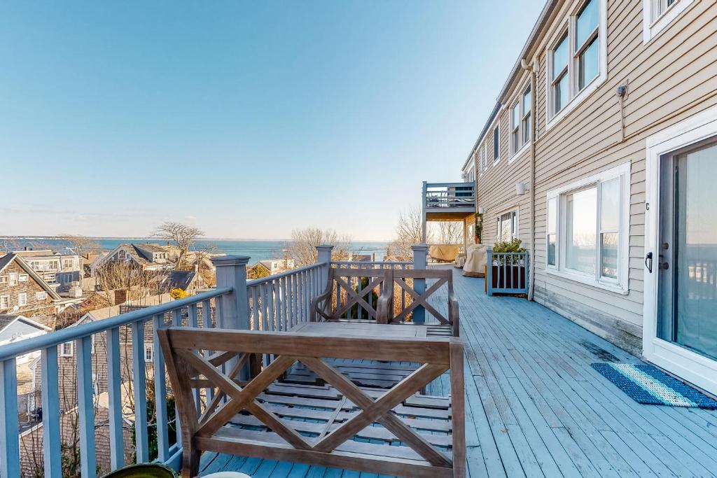 a deck with a bench on the side of a house at A Room With A View in Provincetown